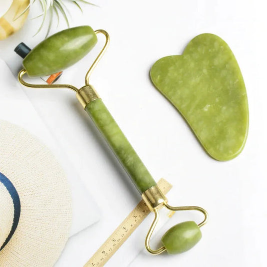 Close-up of a complete 2-in-1 Natural Jade Roller and Gua Sha set with light green, authentic jade stones for facial massage and skincare.