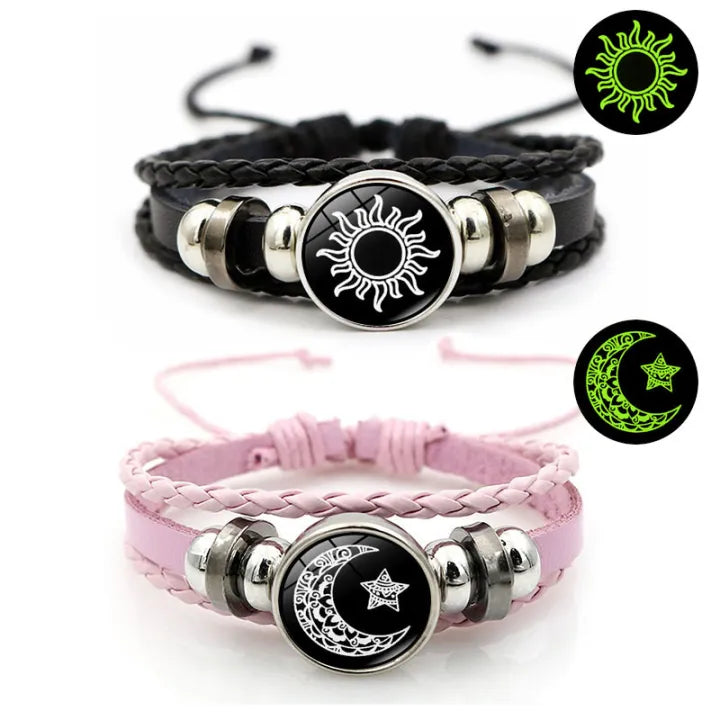 Luminous sun and moon couple bracelets — adjustable black braided cords with silver sun and moon charms on white background.