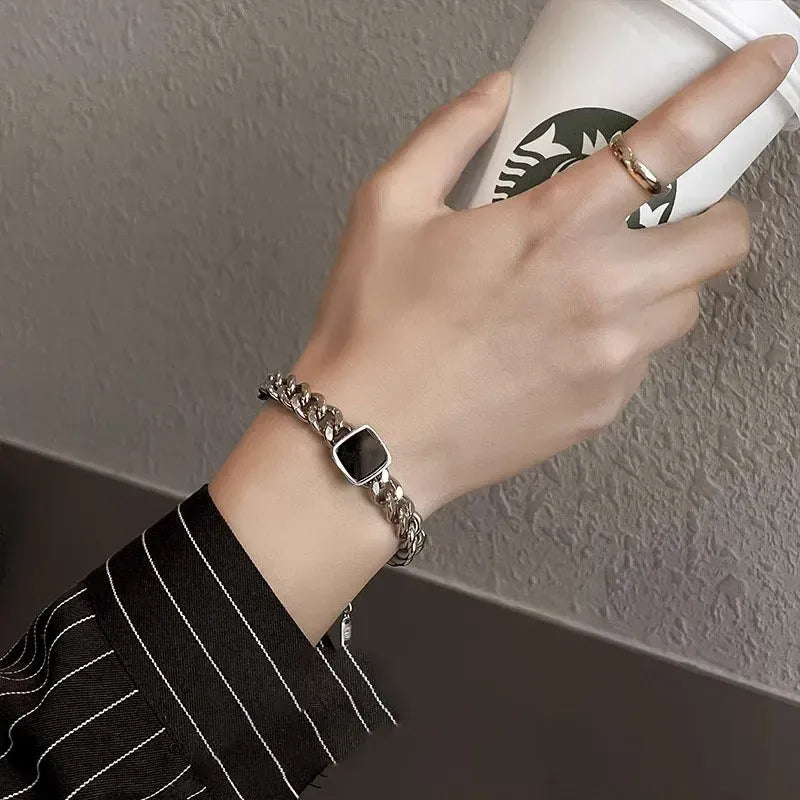 A model's wrist wearing the Square Cuban Titanium Steel Bracelet (His) showing modern fit.